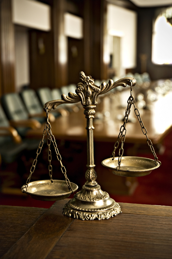justice scale on a courtroom table